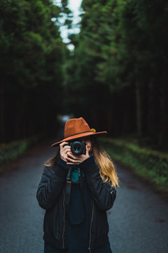 Woman with camera in woods