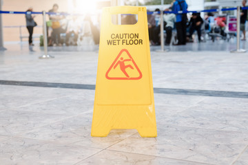 Sign showing warning of caution wet floor at airport.