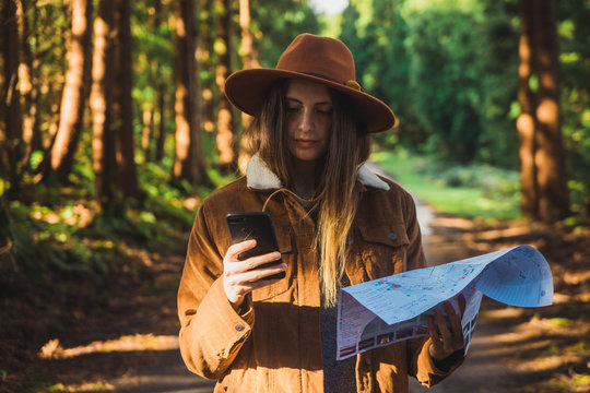 Woman with map in woods