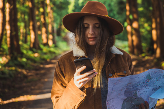 Woman with map in woods
