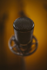 Microphone in recording studio. Unfocused background.