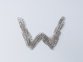 Letter W displayed with paperclips on white background