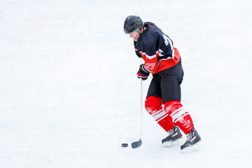 Ice hockey player with stick in attack. Ice hockey game