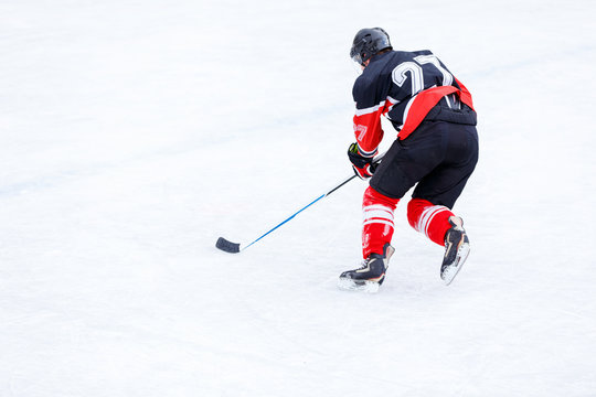 Ice hockey player with stick in attack. Ice hockey game