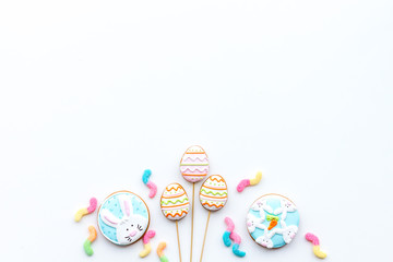 Fototapeta na wymiar Sweets, pastry for Easter table. Easter eggs and Easter bunny concept. White background top view copy space