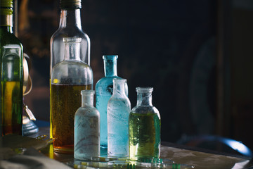 Closeup of old colored bottles on a shelf.