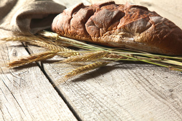 Freshly baked traditional bread on wooden table