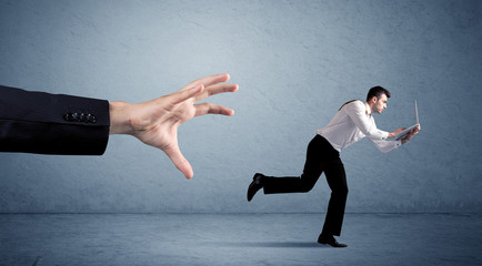 Businessman running from hand