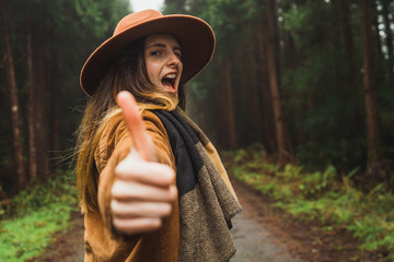Woman making gestures in woods