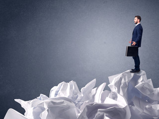 Businessman standing on crumpled paper