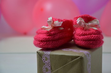 Baby girl knitted sandal, booties, shoes baby newborn, blank postcard. cocept it s a girl or baby shouer