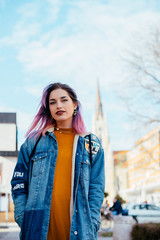 Obraz premium Portrait of a hipster girl with purple hair at city street.