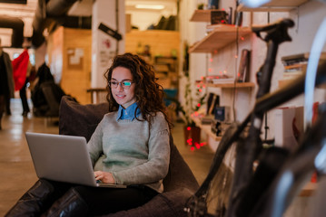 Young woman with laptop in modern environment.