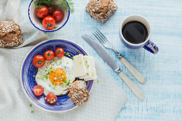 Coffee cup, one egg, cheese and cherry tomatoes for healthy breakfast.