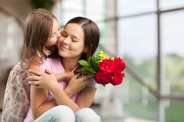 Happy Mother and daughter with flowers