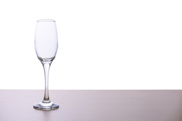 Glass of wine on the wooden table in white background or isolated