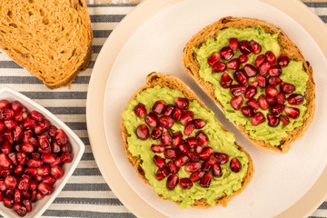 Avocado and Pomegranate Seeds Open Face Sandwich On Mediterranean Bread