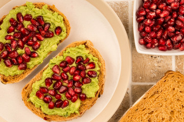 Avocado and Pomegranate Seeds Open Face Sandwich On Mediterranean Bread