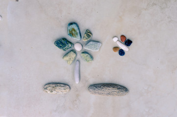 flowers and butterfly made from pebbles