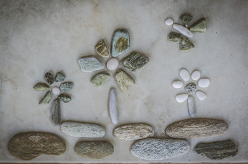 flowers and butterfly made from pebbles