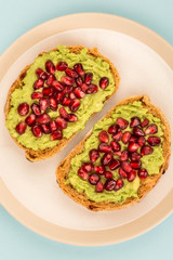 Avocado and Pomegranate Seeds Open Face Sandwich On Mediterranean Bread