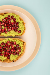 Avocado and Pomegranate Seeds Open Face Sandwich On Mediterranean Bread