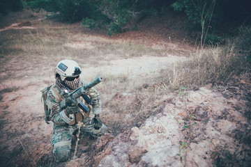 Closeup asian soldier with weapons in hand at the forest,prepare for maneuver,military veterans concept,Thailand army