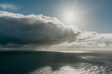 View of the ocean with the big cloud with the rain and the sun