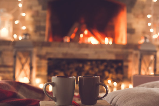 Two cups near the fireplace winter romantic concept
