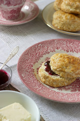 Homemade bread scones with hot tea, traditional British pastries.