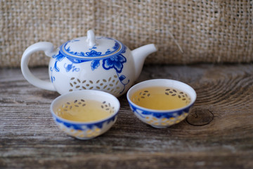 porcelain teapot and two cups with Chinese tea
