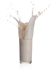 Milk splashing from glass isolated on a white background
