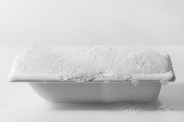 bathtub with foam isolated on a white background