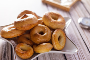 Drying the taralli in a white plate on a pink table