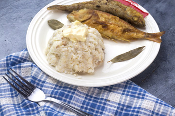 algerian food plate : white rice with mayonnaise and fried fish 