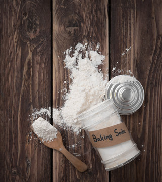 Jar of baking soda with text space on wood background,top view