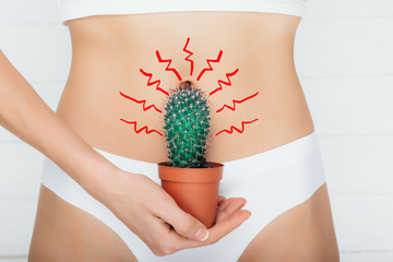 woman dressed in underwear, suffering from stomach ache , gastritis or menstruation, stomach...