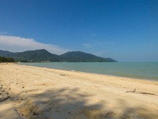 Tropical beach in Teluk bahang with mountains of the National Park in the background - Penang, Malaysia