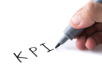 Hand holding black permanent marker and writing word "KPI"on white background