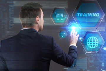 Business, Technology, Internet and network concept. Young businessman working on a virtual screen of the future and sees the inscription: Training