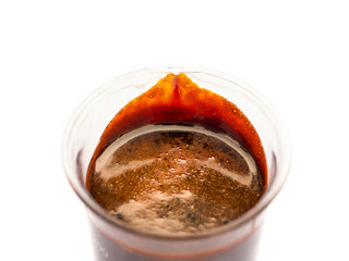 Black treacle or molasses on beaker.  Molasses is the final product from the sugarcane extraction process of sugar factory industrial. Isolate on white background with text space. - Selective focus.