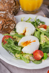 Poached egg with green salad, tomatoes, wholemeal bread and orange juice