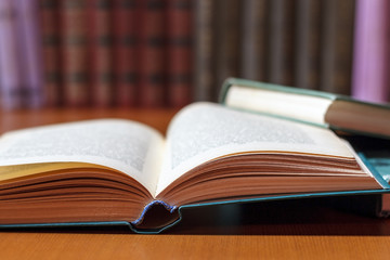 Stacks of colored books on a wooden table. concept of reading habits