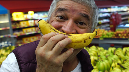 Senior Man Smiling With Banana