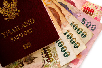 Thai passport with banknotes, Thai currency money on white background for travel abroad, business and finance concept