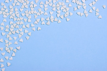 White hearts on blue cardboard or paper background.