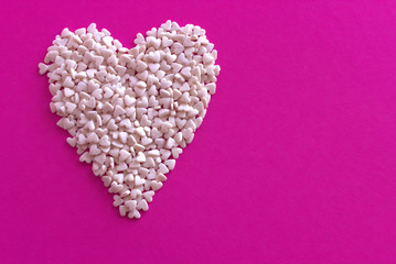 White heart on a purple cardboard background.