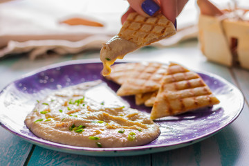 Taramasalata and pita grill on a ceramic violet plate