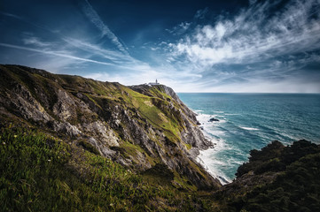 beautiful Atlantic ocean view horizon with lighthouse , flowers and rocks. Sintra,  Portugal