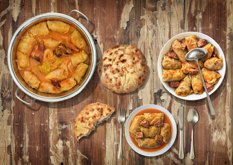 Stuffed Pickled Cabbage Rolls Cooked With Pork Dry Cured Ham And Smoked Ribs Served With Leavened Flatbread On Old Varnished Grunge Cracked Flaky Garden Table